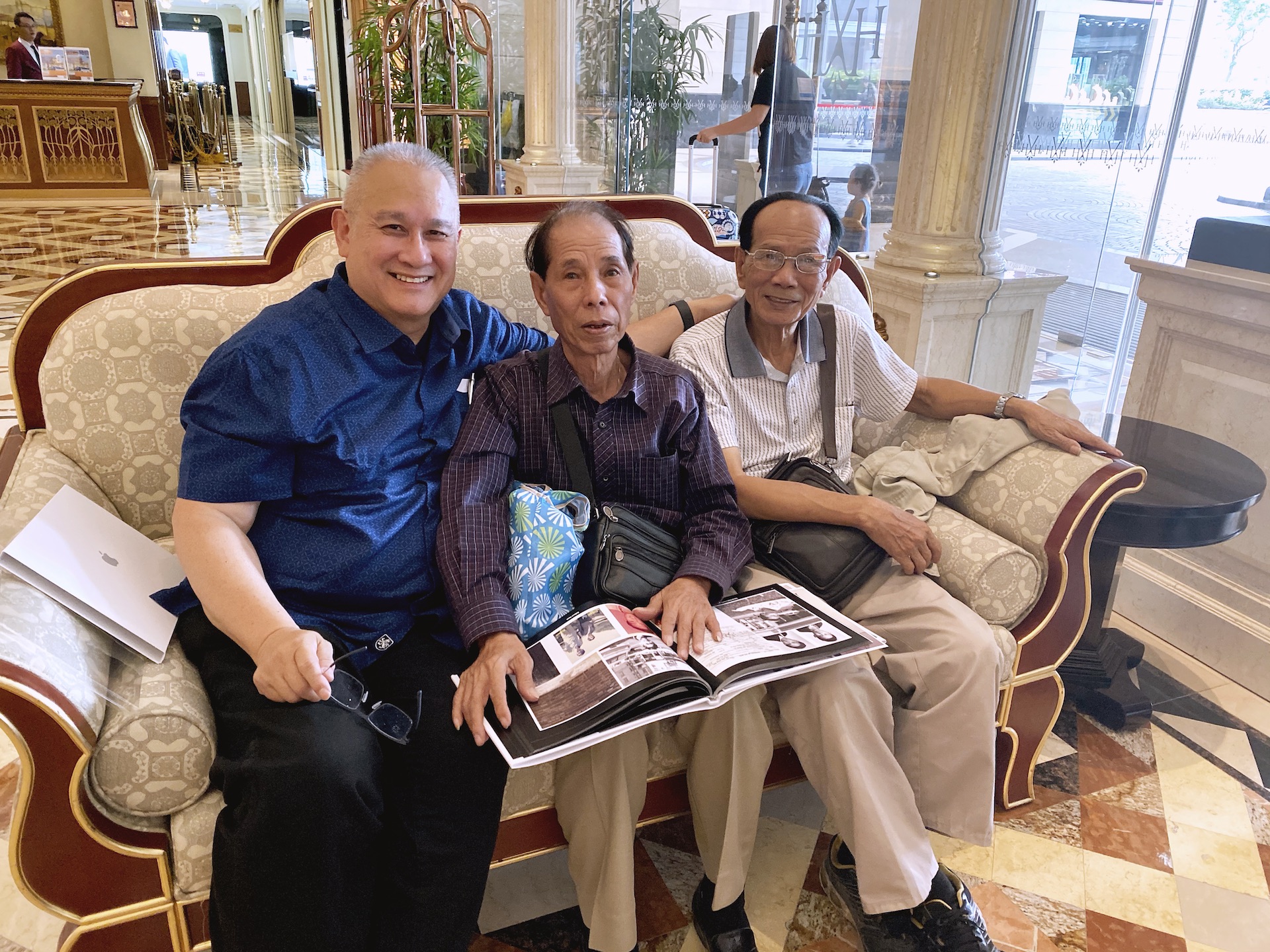 Reunited relatives reading their family history photo-book together