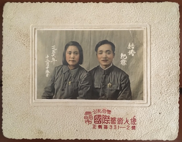 Vintage wedding photo of a couple wearing navy blue Mao era suits