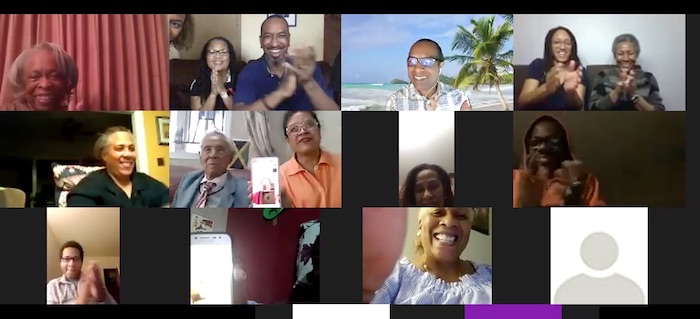 Family members smile and clap while singing happy birthday to their Uncle