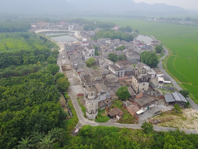 A birdseye view of a Chinese village surrounded by greenery