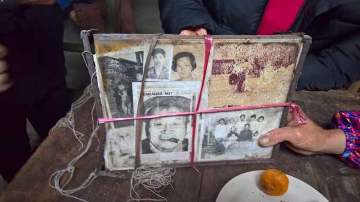 Bundled photos and newspaper clippings found in Sai Wah village.