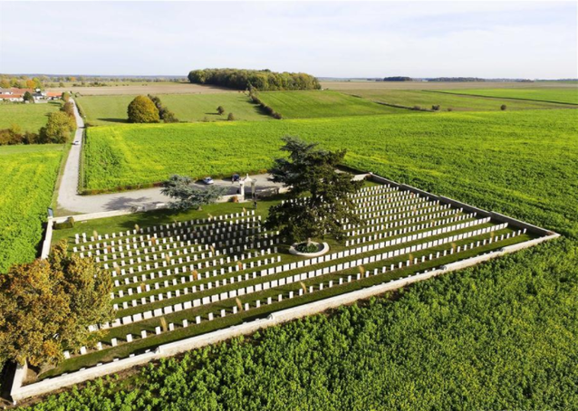 Large green field open space with many Chinese tombstones in Noyelles-sur-Mer cemetery