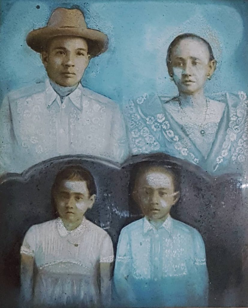 Faded portrait illustrating a Chinese man, his Filipina wife, and their two children in cyan blue and grey watercolors
