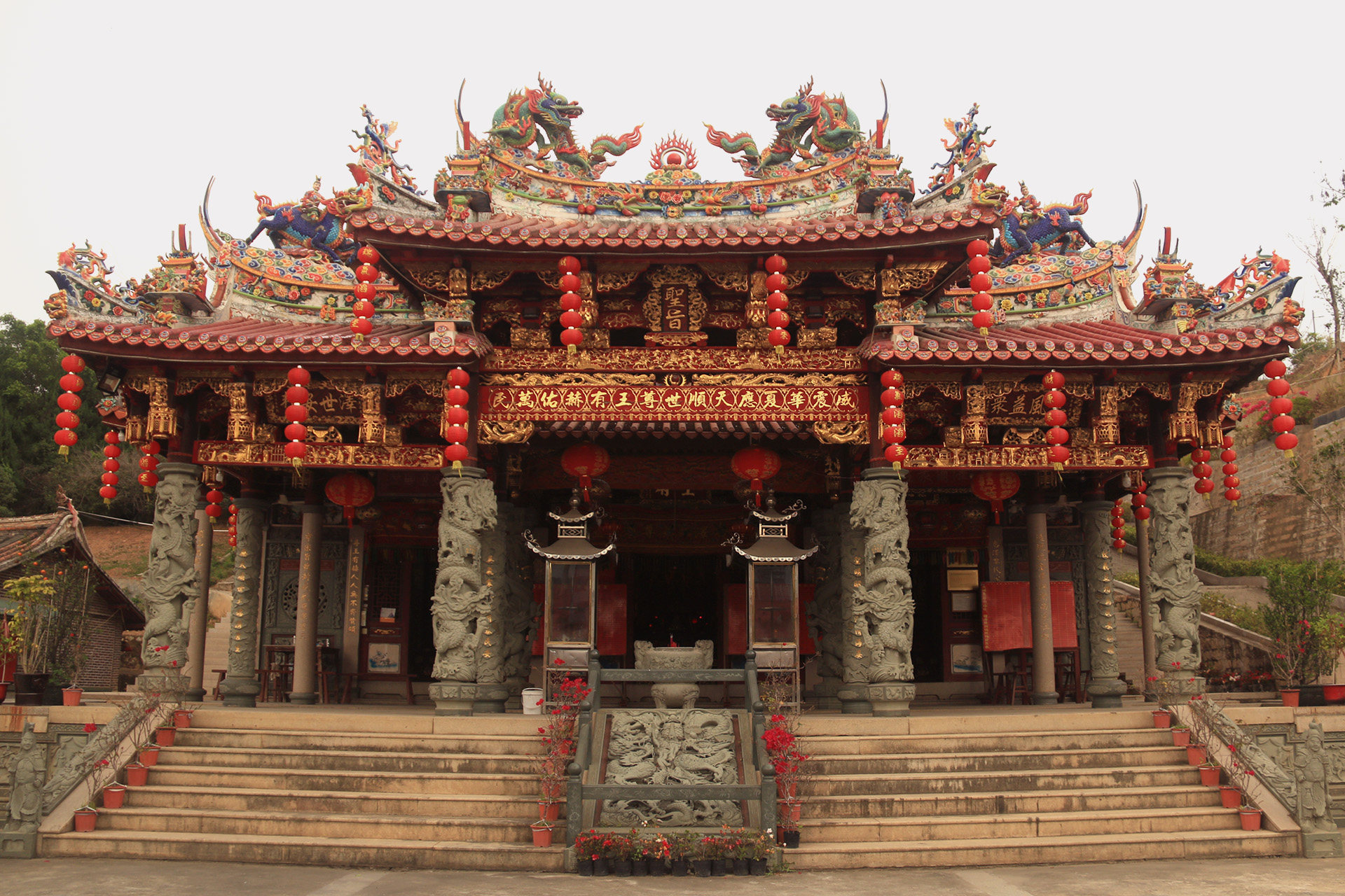 Ornate golden and red facade of the Hui Tek Chun Ong Temple in Puhou, China