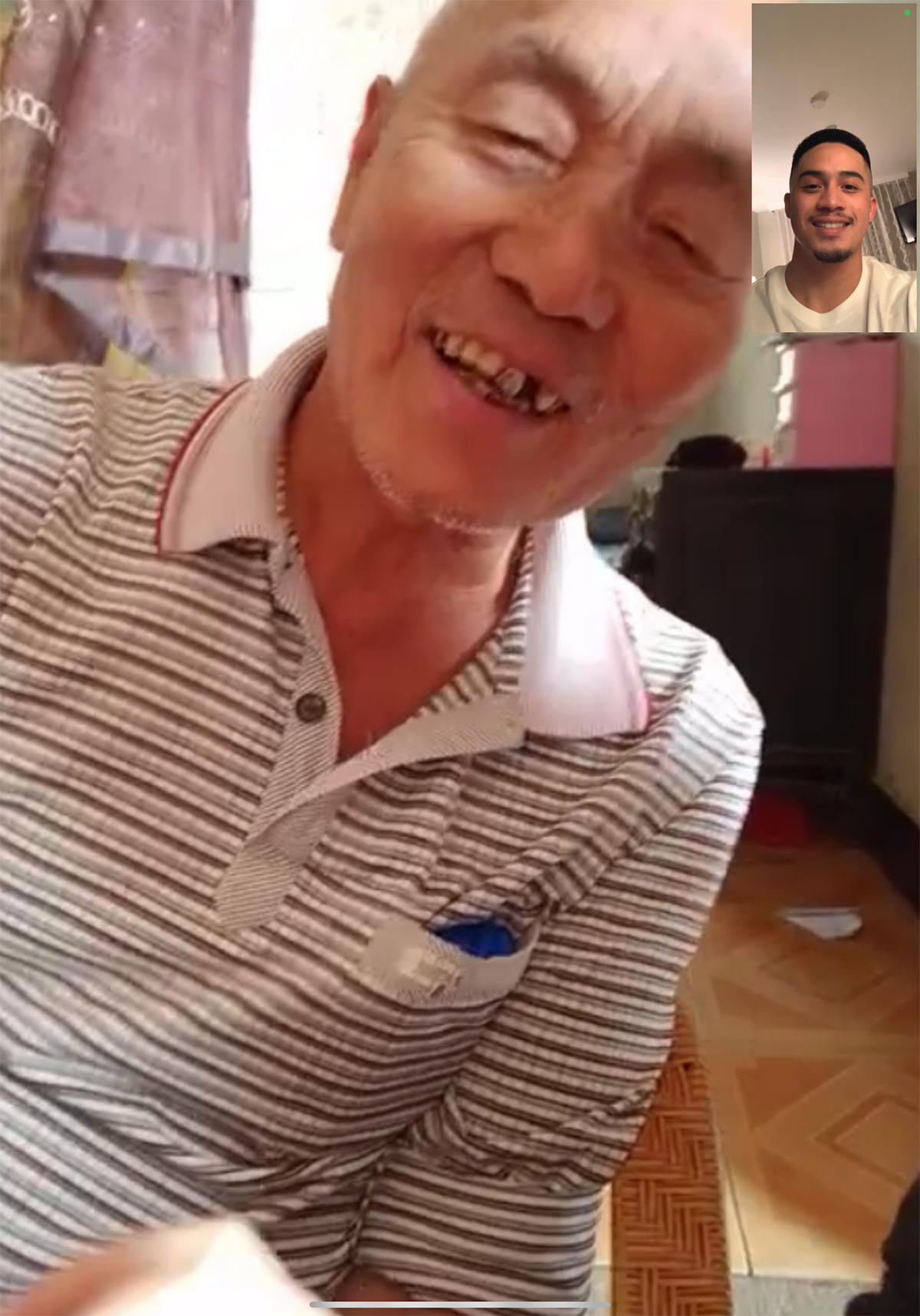 Screenshot of smiling elderly Chinese man meeting young Filipino Chinese man on FaceTime